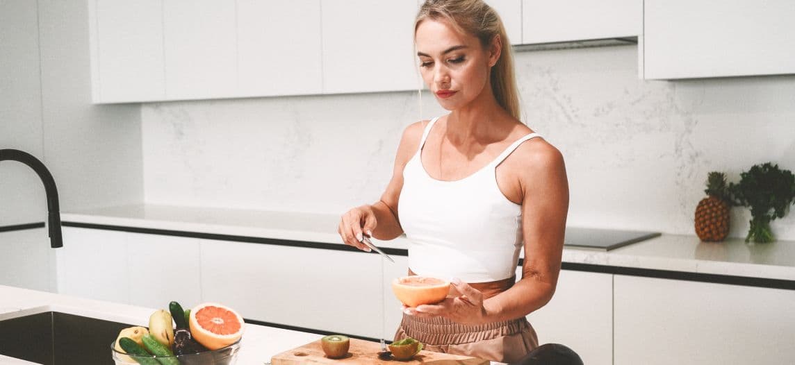 Woman eating orange