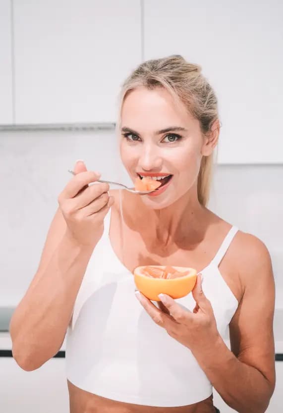 Woman eating orange